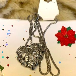 Silver tone necklace with a hollow heart pendant